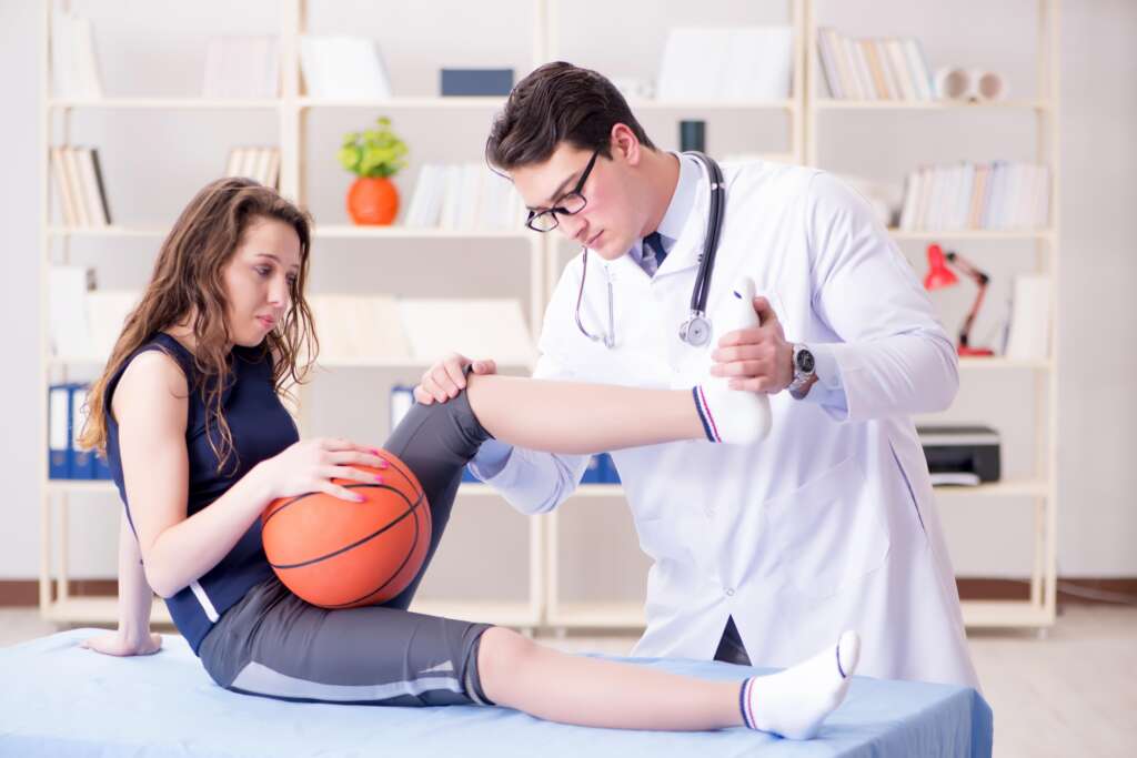 Man doctor taking care of sports injury